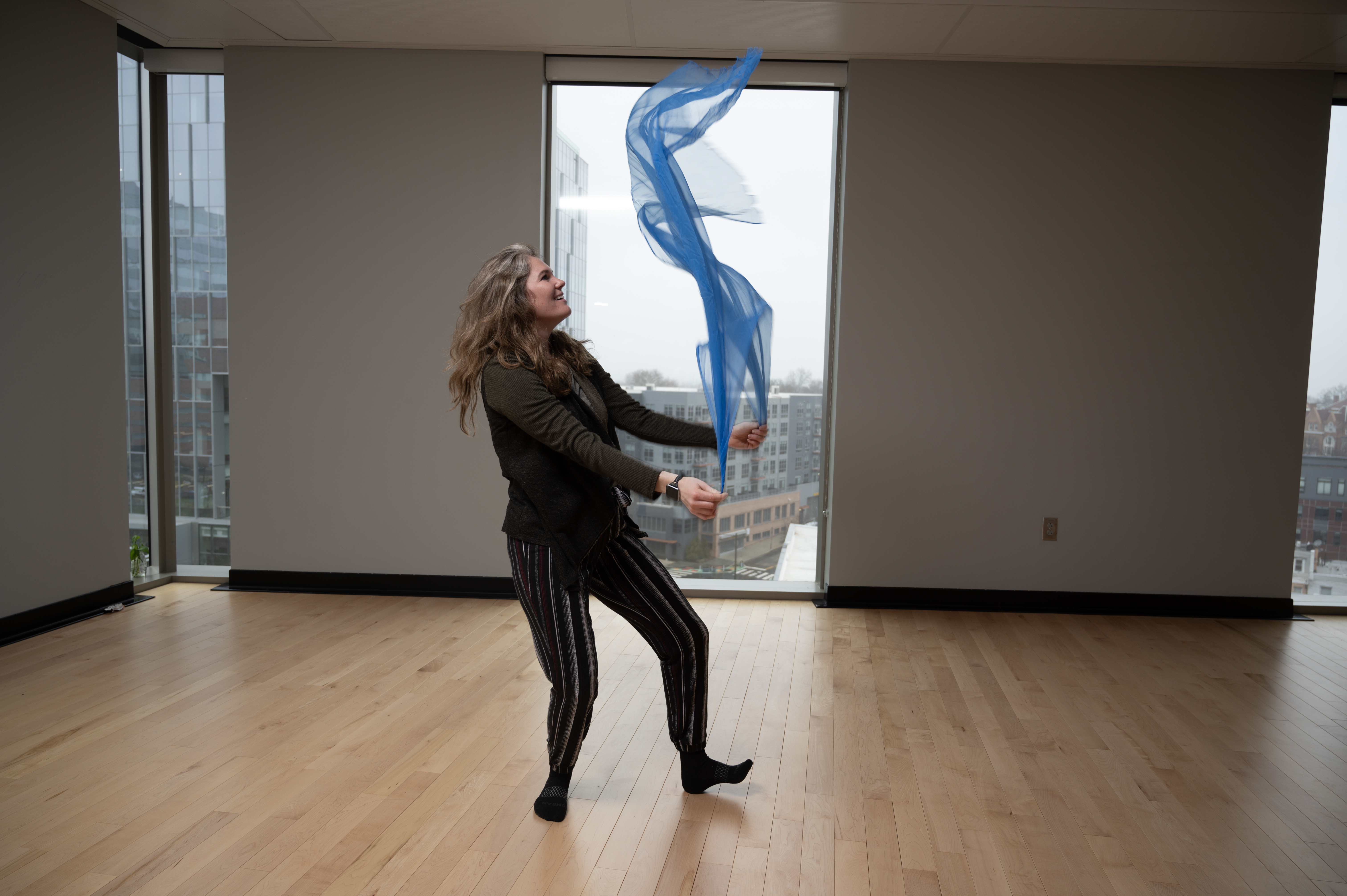 Genevieve Hargrove dancing in studio with a blue scarf
